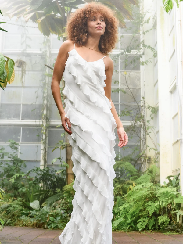 Woman wearing a unique bridal shower dress that is long and flowy