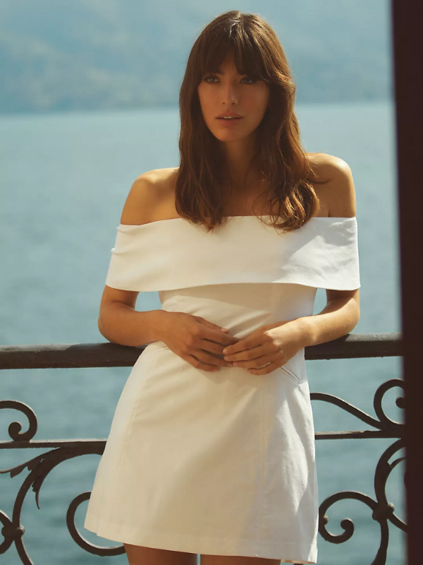 Woman wearing a white, off the shoulder bridal shower dress